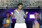 Pop star Justin Bieber, front, performs during a free open-air concert in Mexico City, Monday, June 11, 2012. (AP Photo/Alexandre Meneghini)